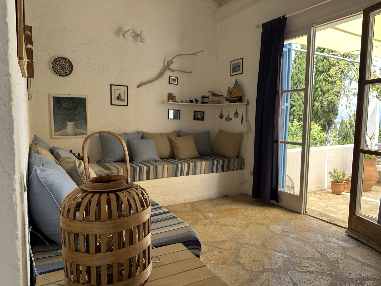 Living room with built-in sofa and Greek decor