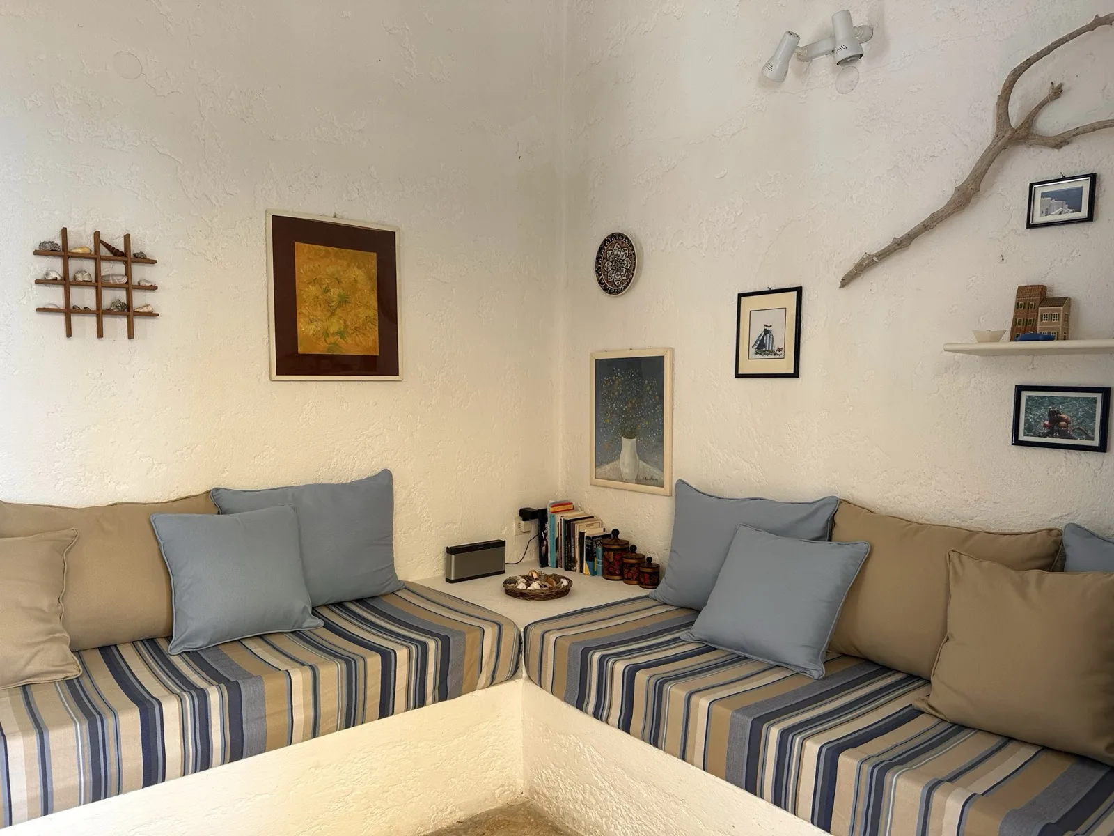 Greek-style living room with built-in sofas and striped cushions