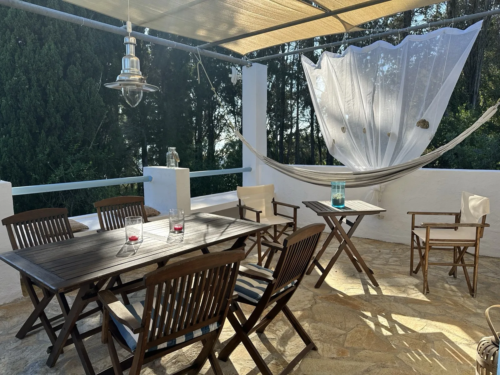 Terrace with hammock, sheer canopy and dining table