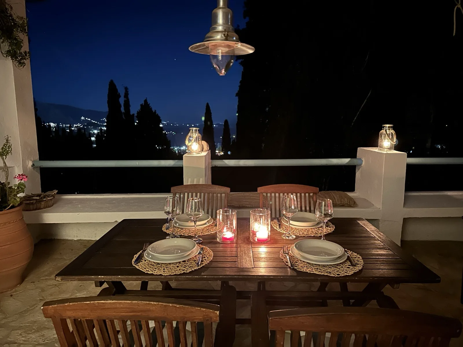 Candlelit dinner table on the terrace at night