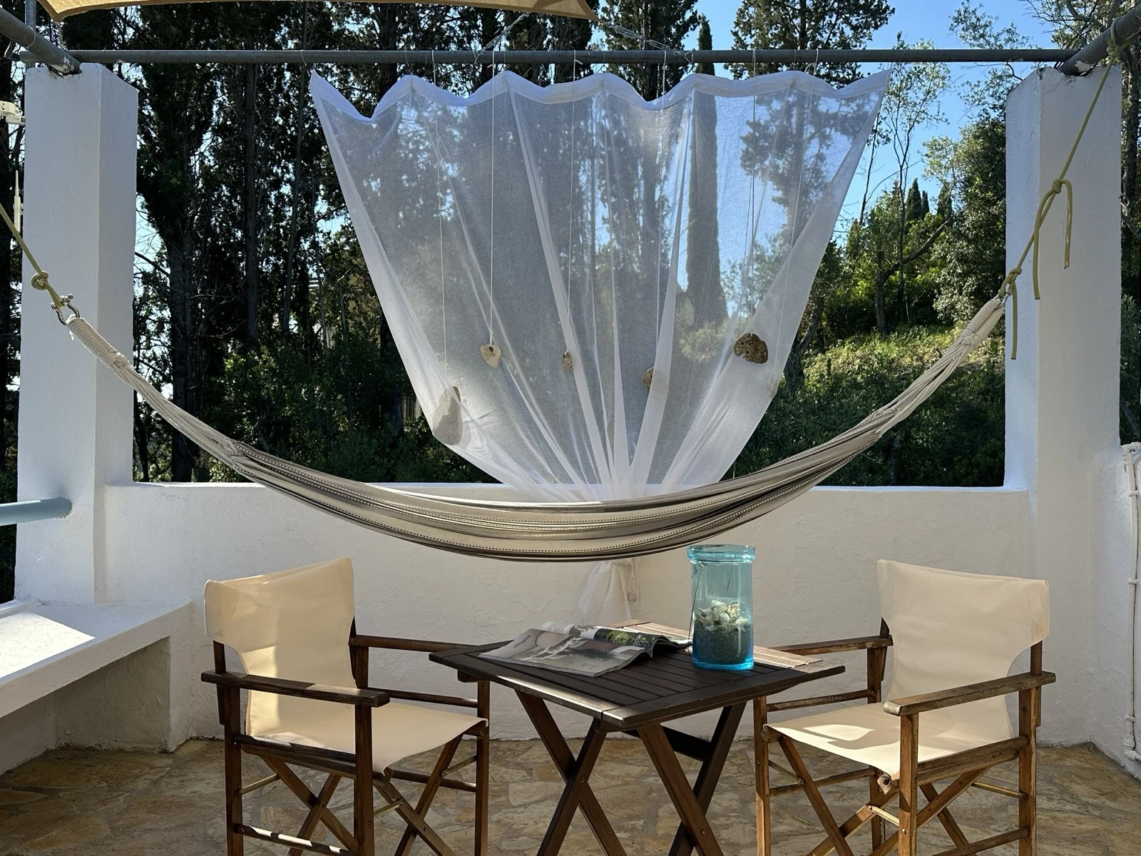 Hammock with white canopy on the sea-view terrace