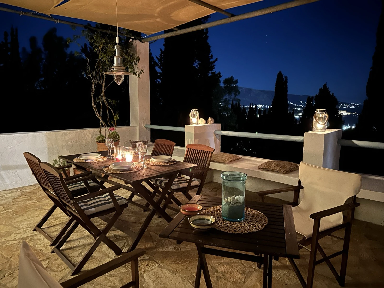 Terrace at night with candles and view of the bay lights